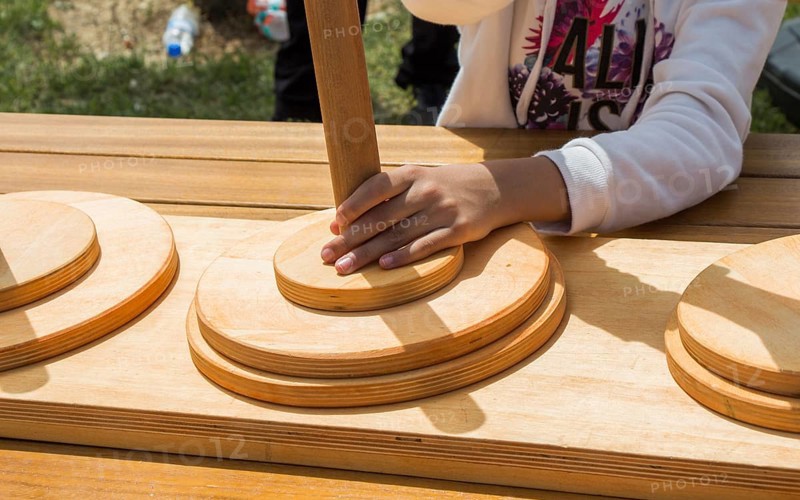 Hand holding wooden puzzle element in hand
