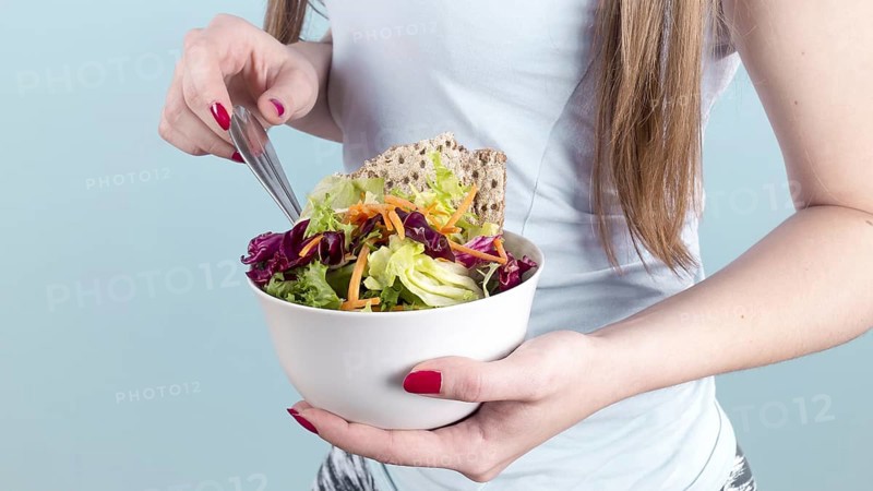 Woman holding big bowl with vegetable salad. Resolution and high quality beautiful photo