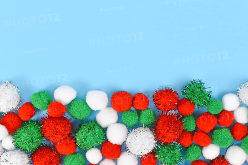Fluffy round pompons in traditional Christmas colors red