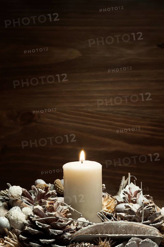 White candle lit with pine cone ornaments. Resolution and high quality beautiful photo