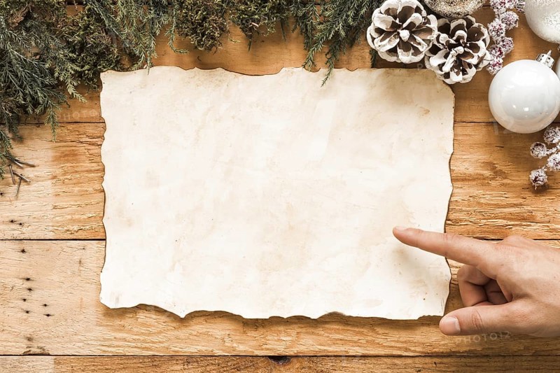 Hand near paper christmas decorations