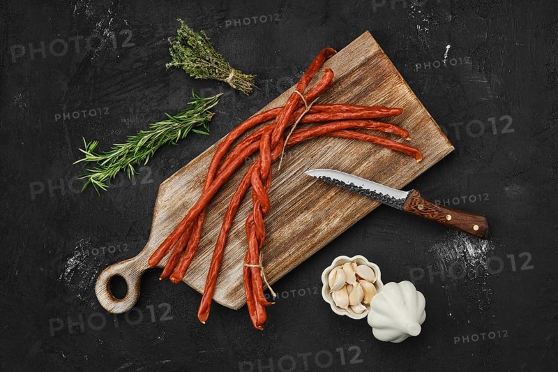 Overhead view of long thin homemade pork sausages with garlic