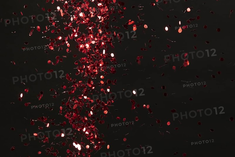 Red glitter on black background