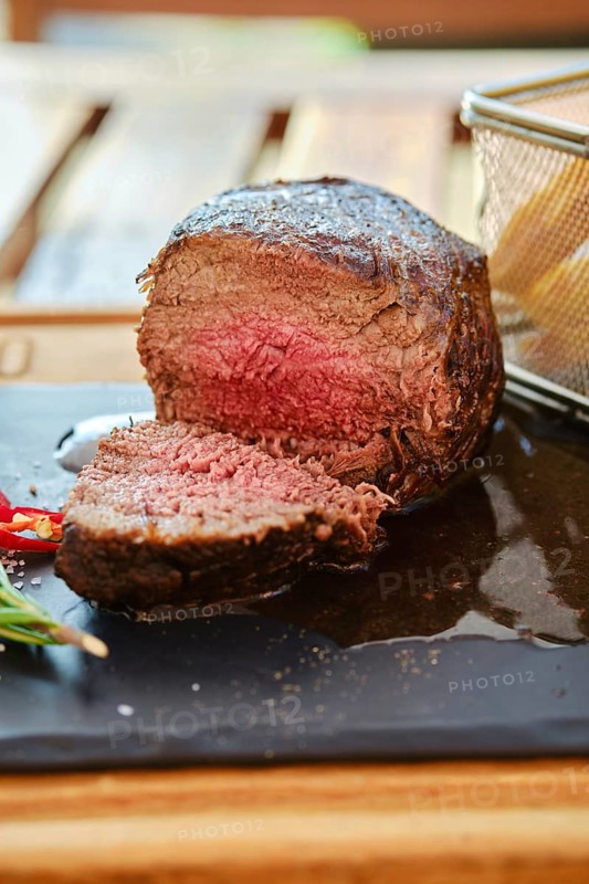 Grilled big fillet mignon beef steak cut on half