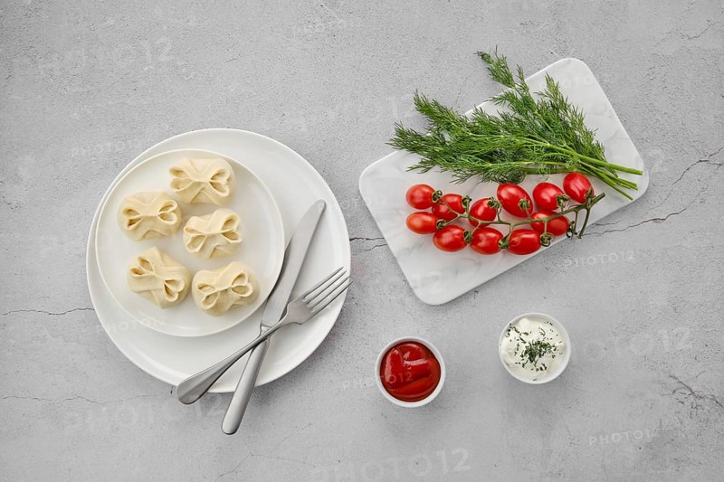 Top view of frozen semifinished manti stuffed with lamb meat