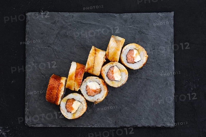 Rolls with eel and cream cheese on slate plate