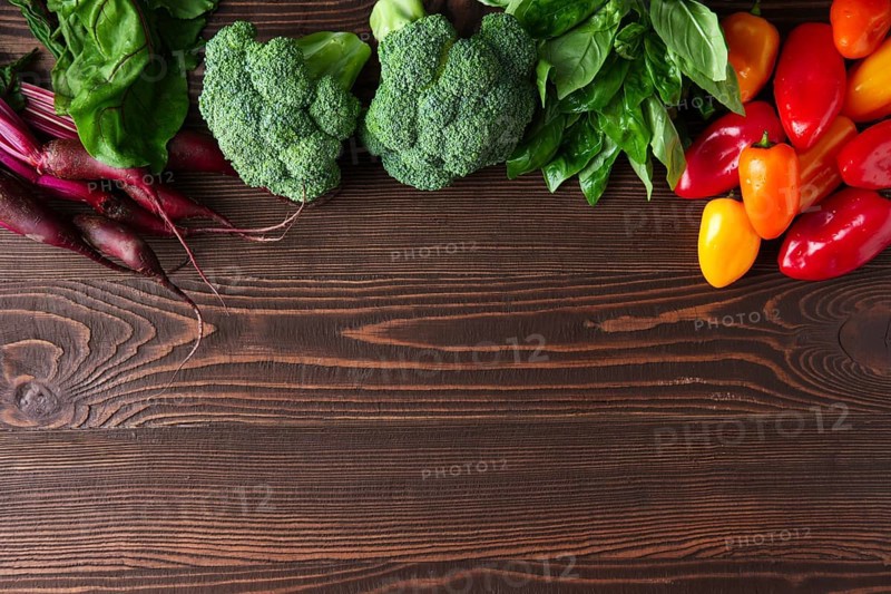 Fresh vegetables on dark wooden background