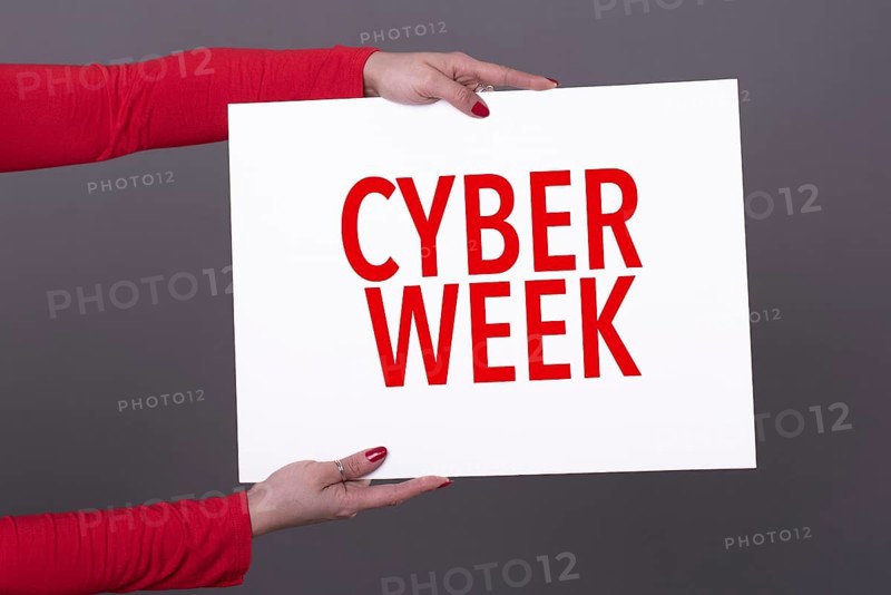 Female hands holding a cyber week poster. Studio shot