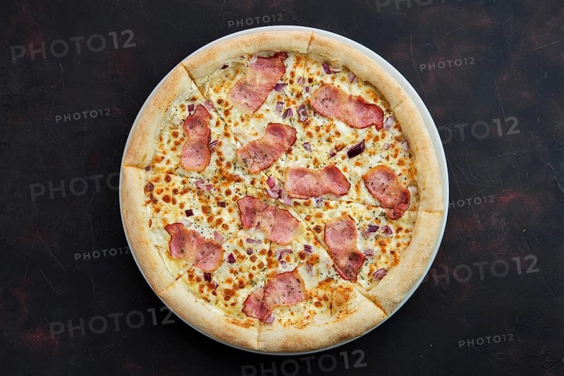 Top view of pizza carbonara with bacon and onion