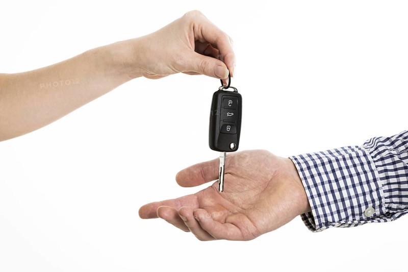 Hands exchanging car keys