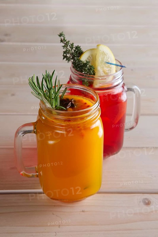 Two cups of cranberry tea and sea buckthorn tea with citrus