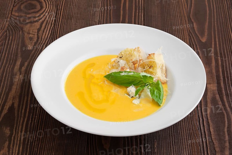Cheese soup with blue cheese and crouton on dark wooden background