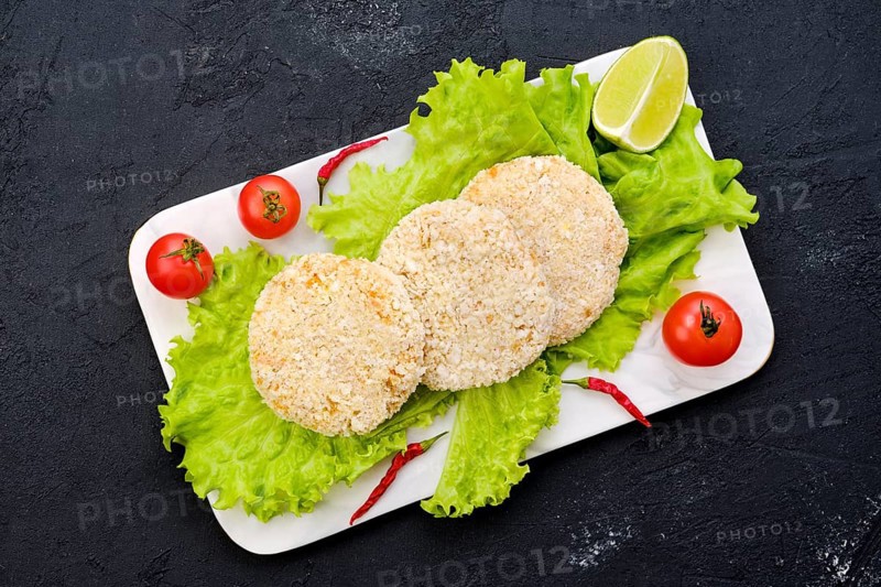 Top view of trout meat cutlet in breading