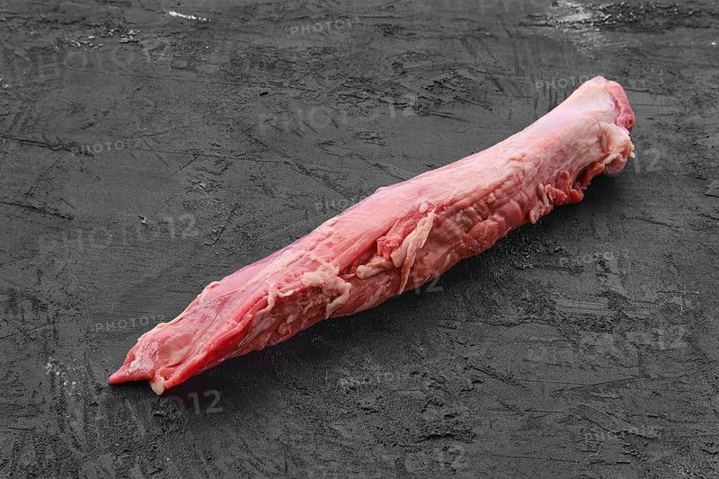 Raw fresh pork fillet on black background