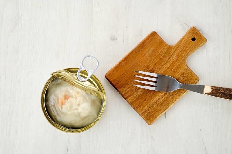 Top view of canned crab meat in open jar