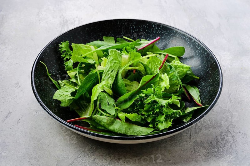 Plate with assortment of fresh salad leaves