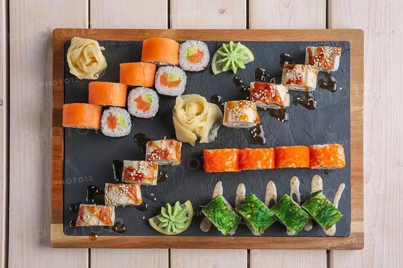 Big set of rolls served on stone plate
