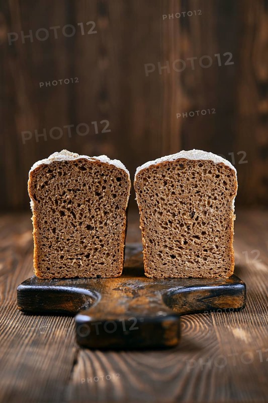 Loaf of artisan rye bread cut on half