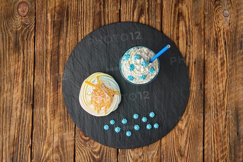 Overhead view of coffee with whipped cream and meringue cake