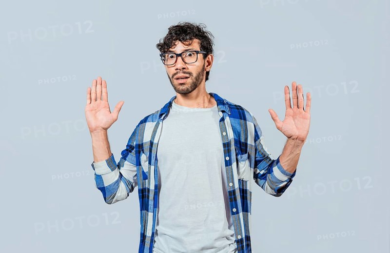 Scared bearded man with raised hands in front. Scared and horrified man with raised palms