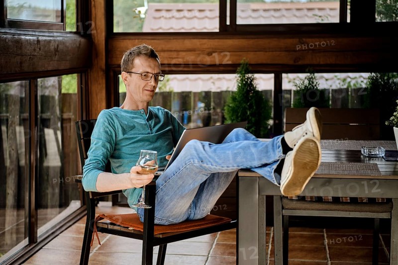Middle aged man wearing glasses using laptop