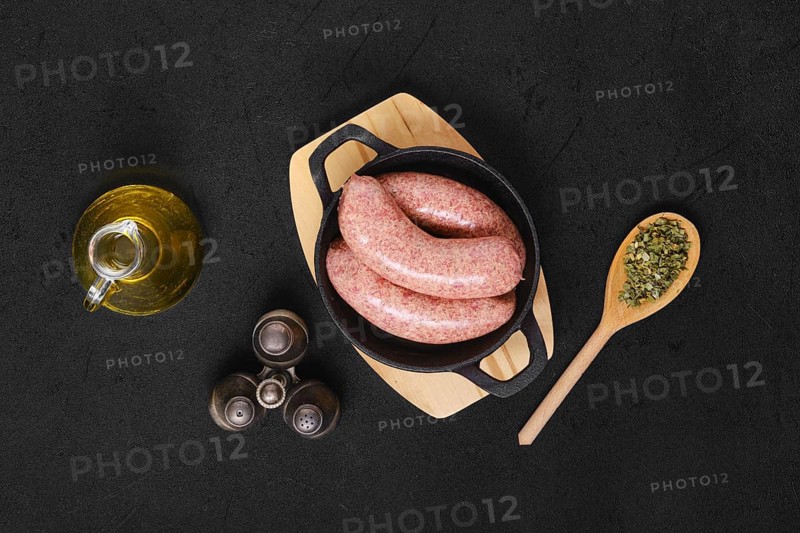 Top view of homemade classic raw beef sausage in cast iron skillet