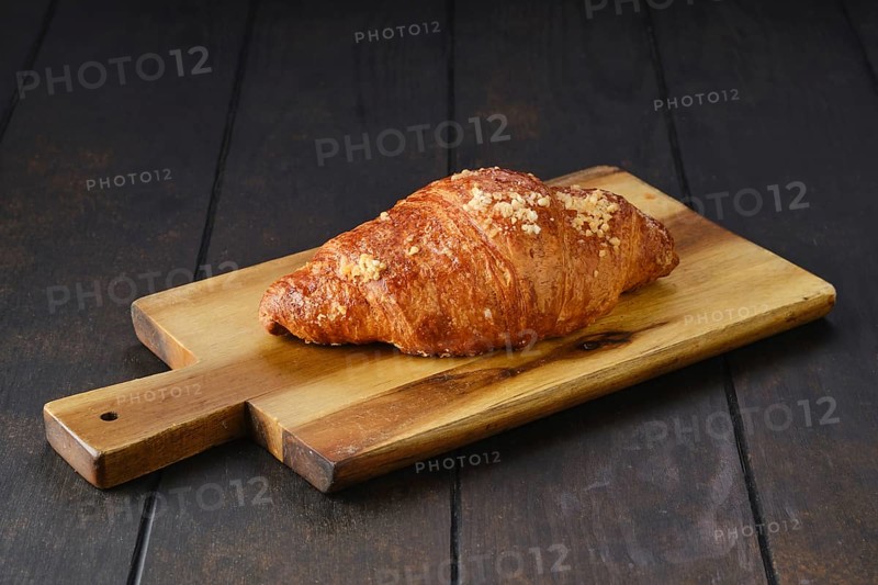 Classic croissant on wooden serving board