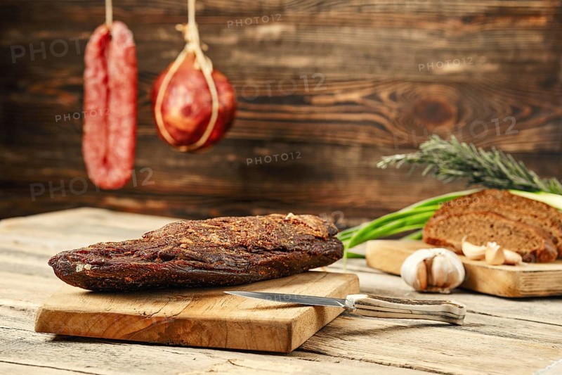 Air dried beef meat on wooden cutting board