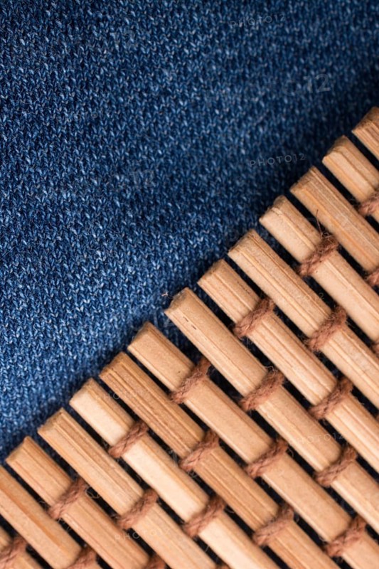 Straw mat placed on denim canvas as a background
