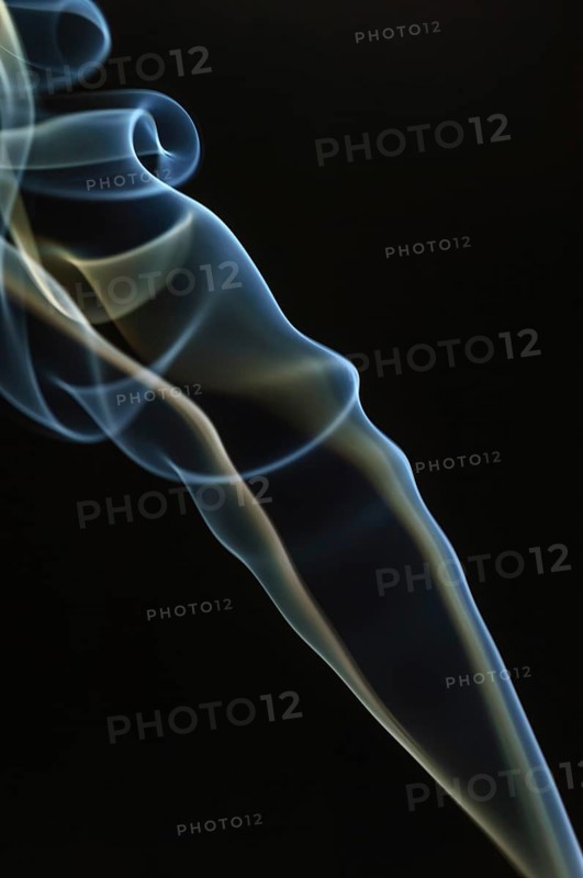 Trajectory of incense smoke in the air showing different shapes. France