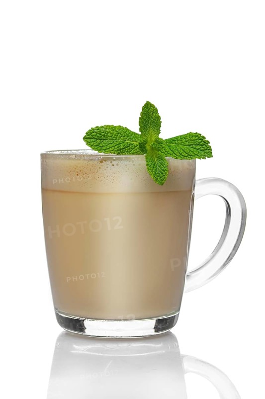 Transparent cup of cappuccino with mint liquor isolated on white