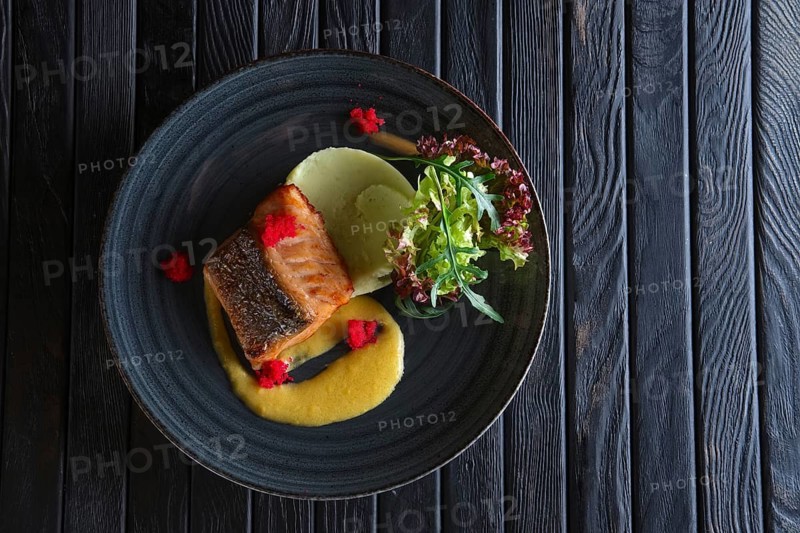 Fried salmon with mashed potato mixed with wasabi and decorated with flying fish roe