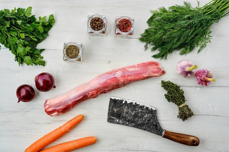 Top view of raw fresh pork fillet with spice on wooden background