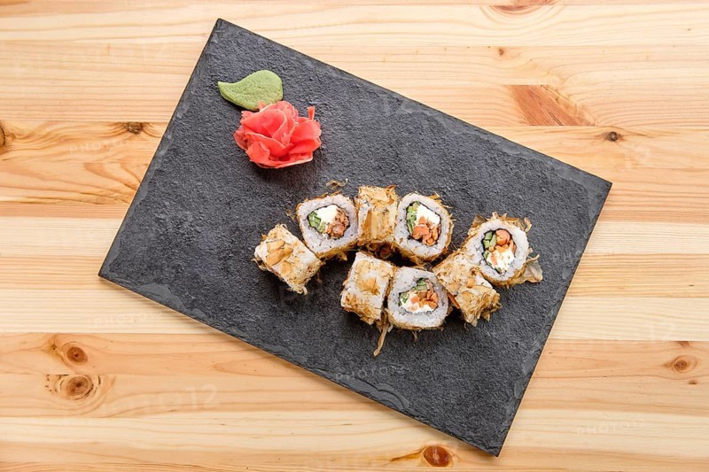 Smoked salmon rolls with cucumber on slate plate