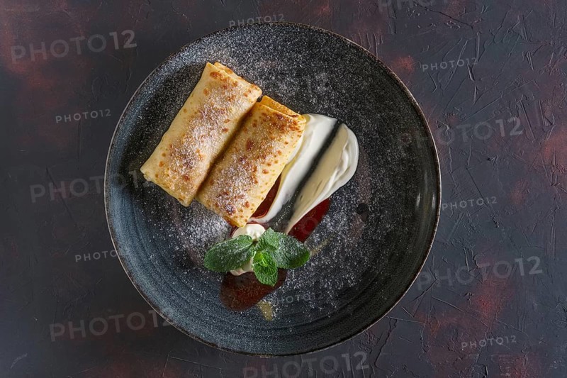 Thin pancakes with curd and sour cream