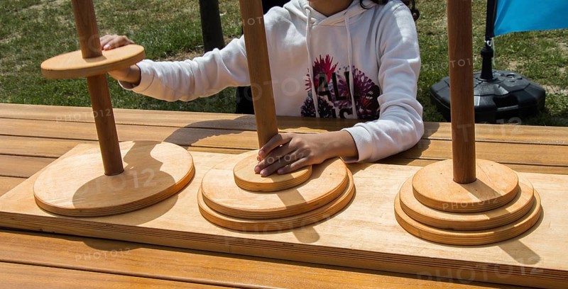 Hand holding wooden puzzle element in hand