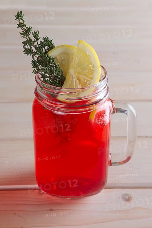 Cup of cranberry juice with citrus and rosemary