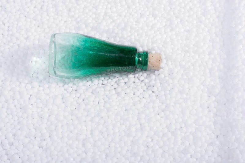 Empty bottle on little white polystyrene foam balls