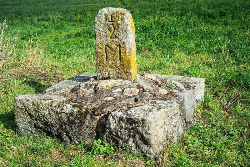 Old milestone on a country road at Roeddinge