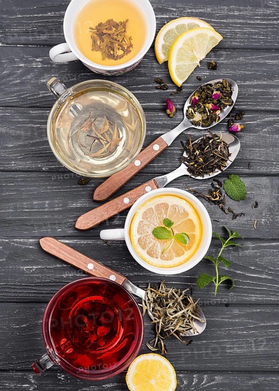 Cup with tea herbs beside
