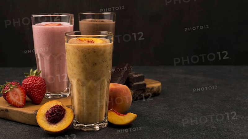 Selection three milkshake glasses with chocolate fruits