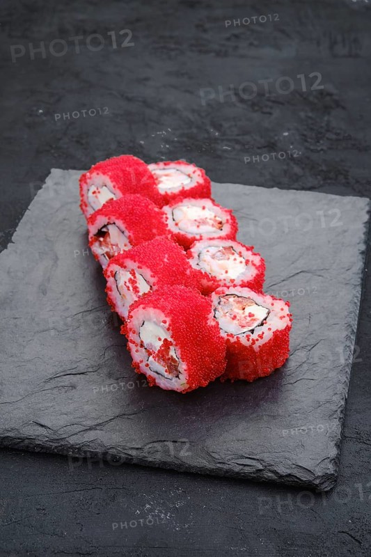 Rolls with shrimp and flying fish roe on slate plate