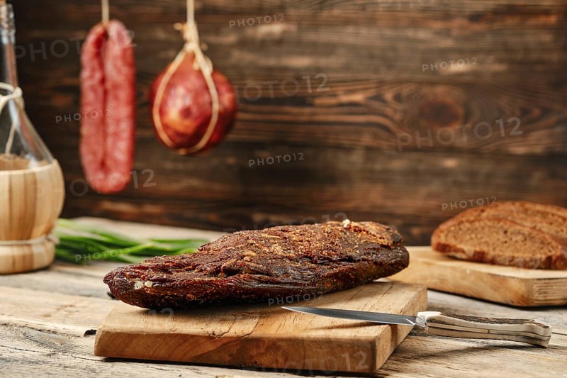 Air dried beef meat on wooden cutting board