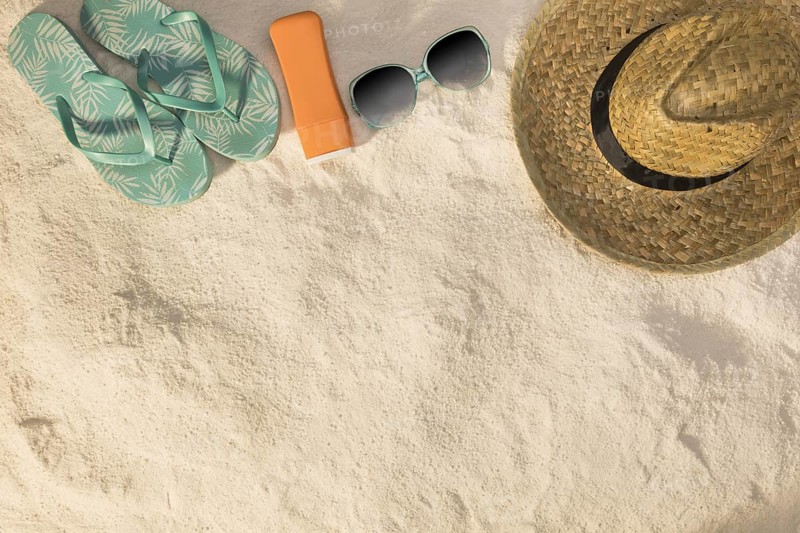 Hat sunglasses blue sandals sunscreen sand