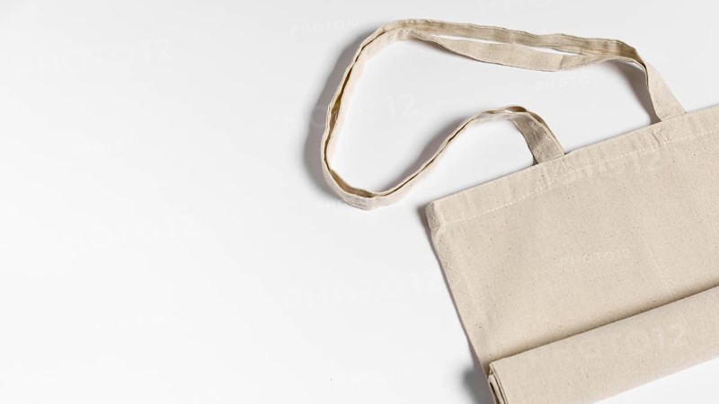 Folded fabric tote bag flat lay