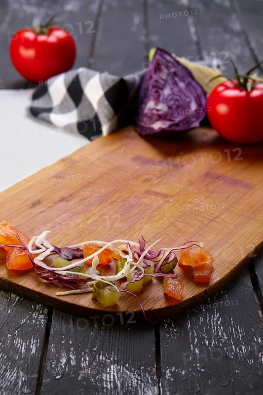 Fresh vegetables on wooden board with a napkin on a table