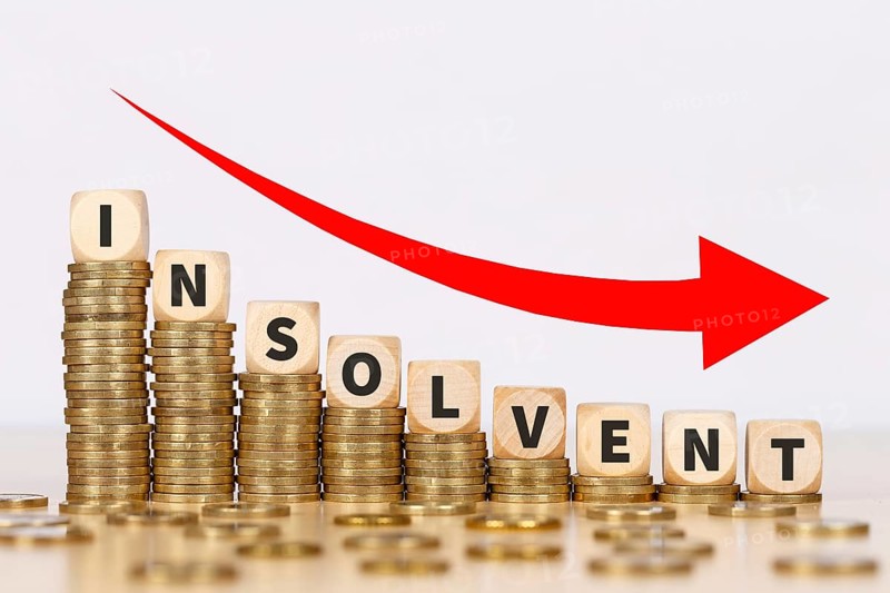 Insolvent symbol image insolvency bankruptcy debt finance and economy money crisis as business concept on coins in Stuttgart