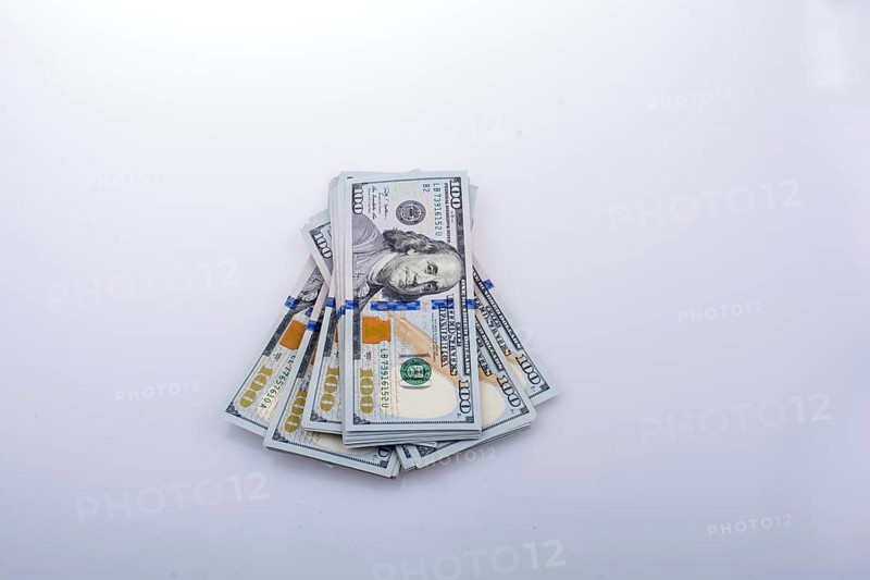 American 100 dollar banknote bundles placed on white background