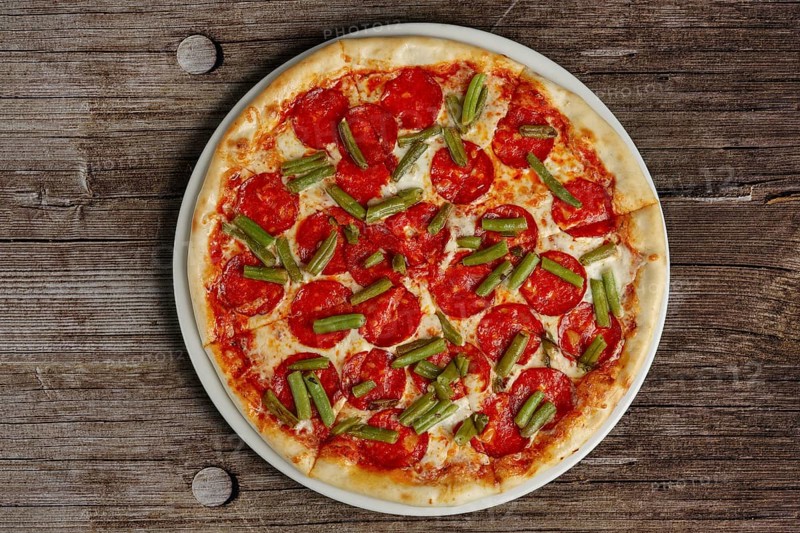 Top view of pizza pepperoni on wooden background