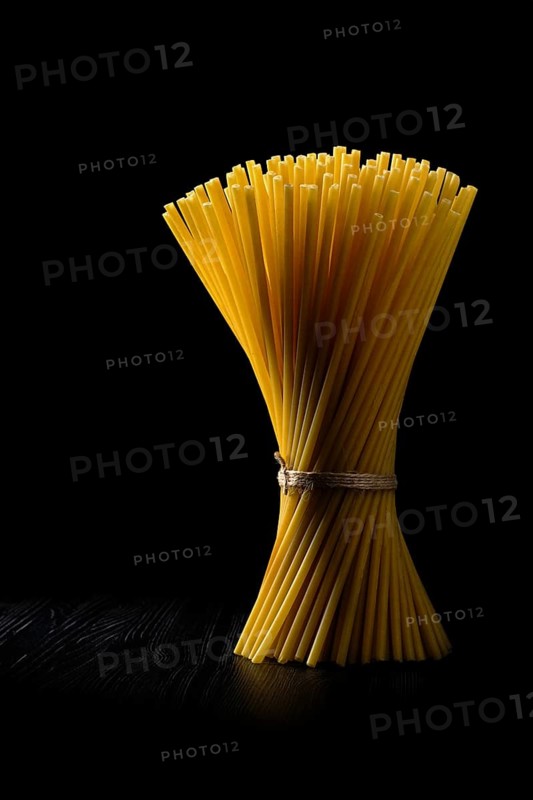 Low key photo of whole wheat ziti pasta. Organic tube spaghetti